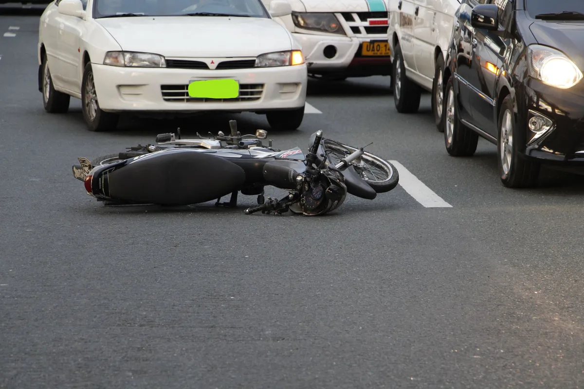 Scène d'accident de moto avec véhicule endommagé et services d'urgence sur place