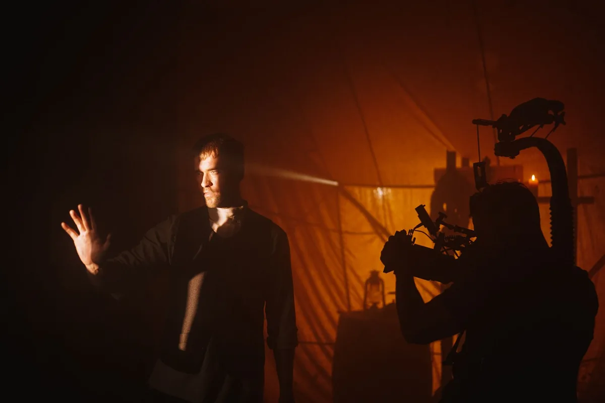 Acteur en gros plan lors d'une scène dramatique, intensité du regard et présence captivante
